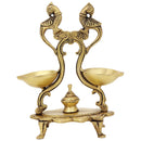 Brass peacock parrot Diya - exquisitely crafted brass oil lamp in the shape of a peacock with parrot motifs, golden finish, decorative home accent, fusion of elegance and vibrancy, traditional Indian Diya, emits a captivating and auspicious glow, perfect for festive occasions and religious ceremonies, enhances spiritual ambiance and decor with a touch of artistic brilliance.