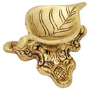 Brass Leaf Diya - elegantly crafted brass oil lamp in the shape of a leaf, golden finish, decorative home accent, inspired by nature's beauty, traditional Indian Diya, emits a soft and serene glow, ideal for religious ceremonies and festive occasions, enhances spiritual ambiance and decor with a touch of natural charm.