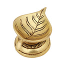 Brass Leaf Diya - elegantly crafted brass oil lamp in the shape of a leaf, golden finish, decorative home accent, inspired by nature's beauty, traditional Indian Diya, emits a soft and serene glow, ideal for religious ceremonies and festive occasions, enhances spiritual ambiance and decor with a touch of natural charm.