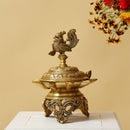 Brass peacock parrot Diya - exquisitely crafted brass oil lamp in the shape of a peacock with parrot motifs, golden finish, decorative home accent, fusion of elegance and vibrancy, traditional Indian Diya, emits a captivating and auspicious glow, perfect for festive occasions and religious ceremonies, enhances spiritual ambiance and decor with a touch of artistic brilliance.