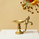 Brass peacock parrot Diya - exquisitely crafted brass oil lamp in the shape of a peacock with parrot motifs, golden finish, decorative home accent, fusion of elegance and vibrancy, traditional Indian Diya, emits a captivating and auspicious glow, perfect for festive occasions and religious ceremonies, enhances spiritual ambiance and decor with a touch of artistic brilliance.