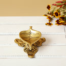 Brass Leaf Diya - elegantly crafted brass oil lamp in the shape of a leaf, golden finish, decorative home accent, inspired by nature's beauty, traditional Indian Diya, emits a soft and serene glow, ideal for religious ceremonies and festive occasions, enhances spiritual ambiance and decor with a touch of natural charm.