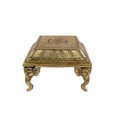 Brass Chowki - intricately carved brass platform, golden finish, perfect for placing deities or sacred objects during religious ceremonies and rituals, enhances the sanctity and beauty of the worship space, symbolizes stability and divine presence, adds a touch of elegance to your home puja setup, a valuable and ornamental addition to your collection of brass religious artifacts and decor.