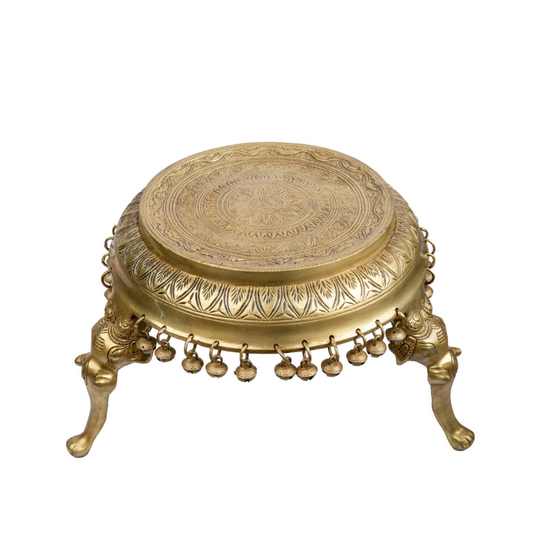 Brass Chowki - intricately carved brass platform, golden finish, perfect for placing deities or sacred objects during religious ceremonies and rituals, enhances the sanctity and beauty of the worship space, symbolizes stability and divine presence, adds a touch of elegance to your home puja setup, a valuable and ornamental addition to your collection of brass religious artifacts and decor.