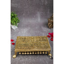 Brass Chowki - intricately carved brass platform, golden finish, perfect for placing deities or sacred objects during religious ceremonies and rituals, enhances the sanctity and beauty of the worship space, symbolizes stability and divine presence, adds a touch of elegance to your home puja setup, a valuable and ornamental addition to your collection of brass religious artifacts and decor.