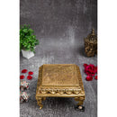 Brass Chowki - intricately carved brass platform, golden finish, perfect for placing deities or sacred objects during religious ceremonies and rituals, enhances the sanctity and beauty of the worship space, symbolizes stability and divine presence, adds a touch of elegance to your home puja setup, a valuable and ornamental addition to your collection of brass religious artifacts and decor.