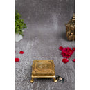 Brass Chowki - intricately carved brass platform, golden finish, perfect for placing deities or sacred objects during religious ceremonies and rituals, enhances the sanctity and beauty of the worship space, symbolizes stability and divine presence, adds a touch of elegance to your home puja setup, a valuable and ornamental addition to your collection of brass religious artifacts and decor.