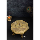 Brass Chowki - intricately carved brass platform, golden finish, perfect for placing deities or sacred objects during religious ceremonies and rituals, enhances the sanctity and beauty of the worship space, symbolizes stability and divine presence, adds a touch of elegance to your home puja setup, a valuable and ornamental addition to your collection of brass religious artifacts and decor.