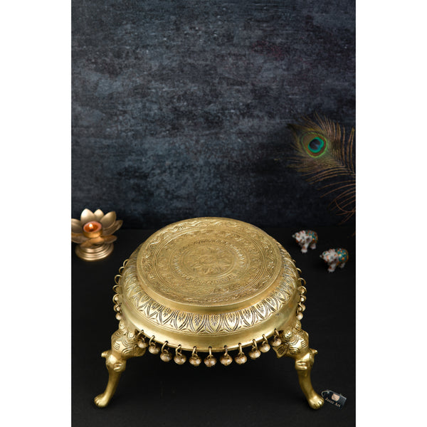 Brass Chowki - intricately carved brass platform, golden finish, perfect for placing deities or sacred objects during religious ceremonies and rituals, enhances the sanctity and beauty of the worship space, symbolizes stability and divine presence, adds a touch of elegance to your home puja setup, a valuable and ornamental addition to your collection of brass religious artifacts and decor.