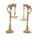 Brass peacock parrot Diya - exquisitely crafted brass oil lamp in the shape of a peacock with parrot motifs, golden finish, decorative home accent, fusion of elegance and vibrancy, traditional Indian Diya, emits a captivating and auspicious glow, perfect for festive occasions and religious ceremonies, enhances spiritual ambiance and decor with a touch of artistic brilliance.