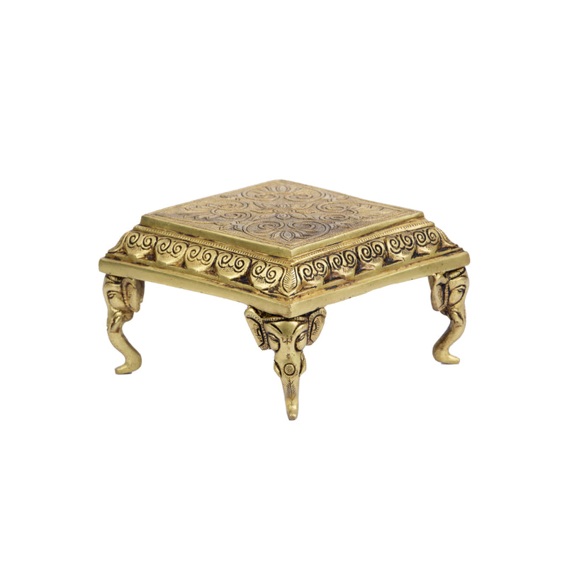 Brass Chowki - intricately carved brass platform, golden finish, perfect for placing deities or sacred objects during religious ceremonies and rituals, enhances the sanctity and beauty of the worship space, symbolizes stability and divine presence, adds a touch of elegance to your home puja setup, a valuable and ornamental addition to your collection of brass religious artifacts and decor.