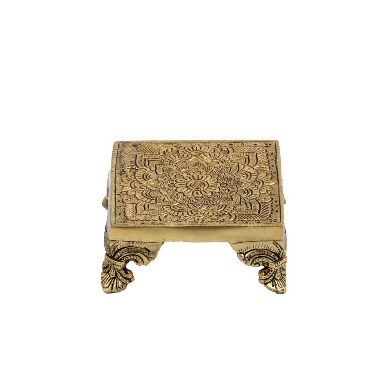 Brass Chowki - intricately carved brass platform, golden finish, perfect for placing deities or sacred objects during religious ceremonies and rituals, enhances the sanctity and beauty of the worship space, symbolizes stability and divine presence, adds a touch of elegance to your home puja setup, a valuable and ornamental addition to your collection of brass religious artifacts and decor.