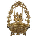 Brass Radha Krishna Ji Urli - intricately designed brass decorative bowl featuring idols of Radha and Krishna, golden finish, traditional Indian Urli, auspicious home accent, ideal for floating flower petals or candles, symbolizes divine love and devotion, adds a touch of spirituality and cultural beauty to any space, perfect for creating a serene ambiance and enhancing interior decor, a timeless piece of art for both indoor and outdoor settings.