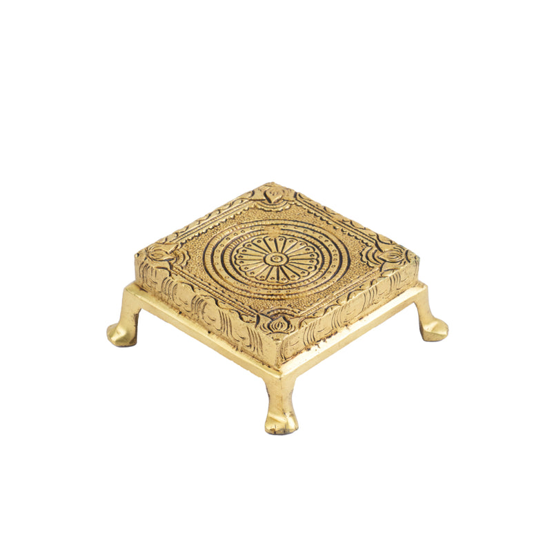 Brass Chowki - intricately carved brass platform, golden finish, perfect for placing deities or sacred objects during religious ceremonies and rituals, enhances the sanctity and beauty of the worship space, symbolizes stability and divine presence, adds a touch of elegance to your home puja setup, a valuable and ornamental addition to your collection of brass religious artifacts and decor.