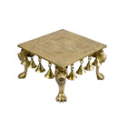 Brass Chowki - intricately carved brass platform, golden finish, perfect for placing deities or sacred objects during religious ceremonies and rituals, enhances the sanctity and beauty of the worship space, symbolizes stability and divine presence, adds a touch of elegance to your home puja setup, a valuable and ornamental addition to your collection of brass religious artifacts and decor.