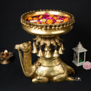 Brass Camel Urli - exquisitely designed brass decorative bowl adorned with camel motifs, golden finish, traditional Indian Urli, versatile home accent, ideal for floating flower petals or candles, symbolizes resilience and adventure, adds a touch of cultural charm and elegance to any space, perfect for creating a captivating ambiance and enhancing interior decor, a timeless piece of art for both indoor and outdoor settings.