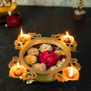 Brass 4 Diya Urli - beautifully crafted brass decorative bowl with four diya (oil lamp) holders, golden finish, traditional Indian Urli, versatile home accent, ideal for lighting multiple diya simultaneously, adds a touch of warmth and radiance to any space, perfect for creating a festive ambiance and enhancing interior decor, a charming centerpiece for religious ceremonies and celebratory occasions.