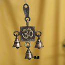 Brass OM Bells - intricately designed brass bells in the shape of the sacred Om symbol, golden finish, decorative home accent, emits a soothing and resonant sound, perfect for creating a calming and spiritual ambiance, ideal for meditation, yoga, and spiritual practices, symbolizes unity and divine energy, enhances the atmosphere with positive vibrations, a meaningful addition to your collection of brass artifacts