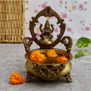 Brass Lakshmi & Ganesh Ji Urli - intricately crafted brass decorative bowl featuring idols of Goddess Lakshmi and Lord Ganesh, golden finish, traditional Indian Urli, versatile home accent, ideal for floating flower petals or candles, symbolizes prosperity and blessings, adds a touch of divinity and cultural richness to any space, perfect for creating an auspicious ambiance and enhancing interior decor, a timeless piece of art for both indoor and outdoor settings.