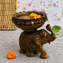 Brass Elephant Urli - meticulously designed brass decorative bowl featuring elephant motifs, golden finish, traditional Indian Urli, versatile home accent, ideal for floating flower petals or candles, symbolizes strength and wisdom, adds a touch of cultural charm and serenity to any space, perfect for creating an inviting ambiance and enhancing interior decor, a timeless piece of art for both indoor and outdoor settings.